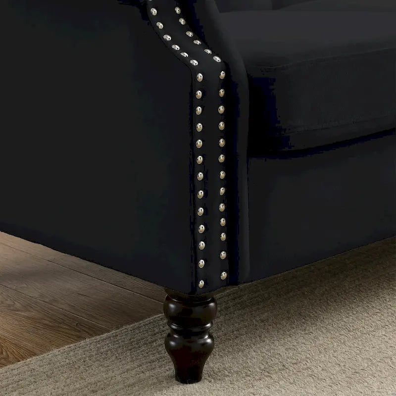 Made of black velvet, suitable for the living room. Three-seater sofa with tufted fabric, rolled-edge armrests, and studded details.