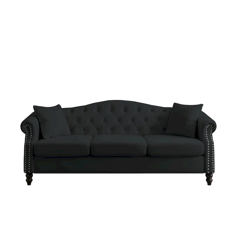 Made of black velvet, suitable for the living room. Three-seater sofa with tufted fabric, rolled-edge armrests, and studded details.