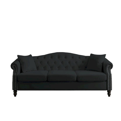 Made of black velvet, suitable for the living room. Three-seater sofa with tufted fabric, rolled-edge armrests, and studded details.