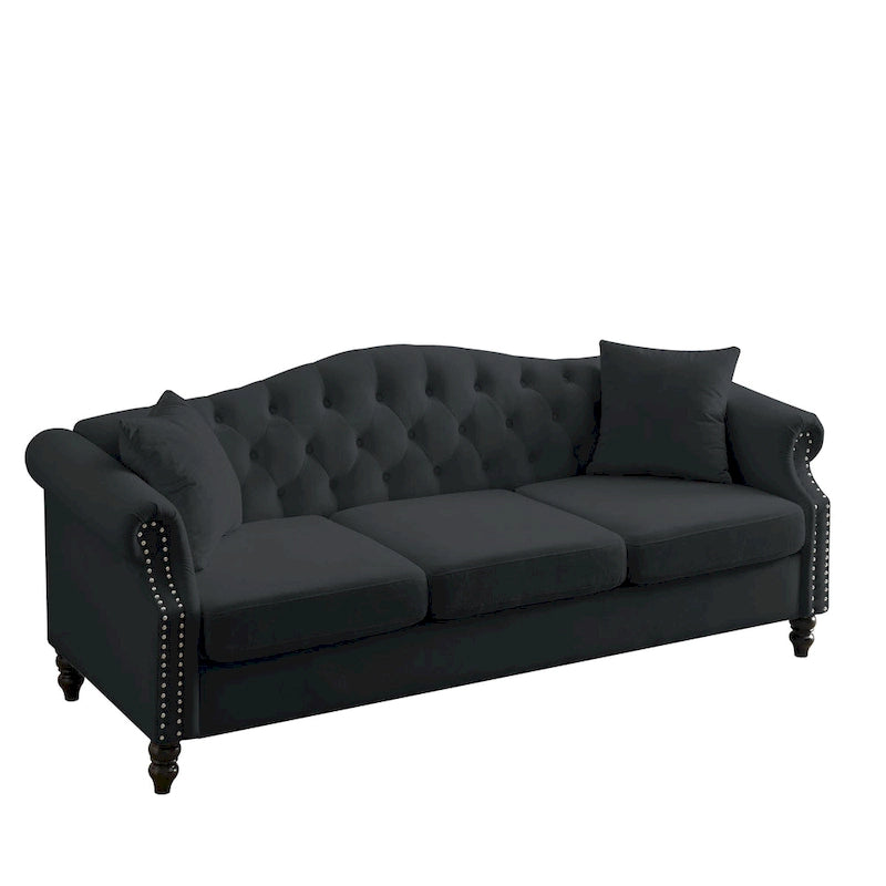 Made of black velvet, suitable for the living room. Three-seater sofa with tufted fabric, rolled-edge armrests, and studded details.