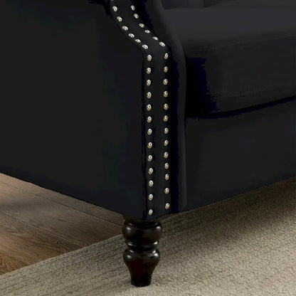 Made of black velvet, suitable for the living room. Three-seater sofa with tufted fabric, rolled-edge armrests, and studded details.
